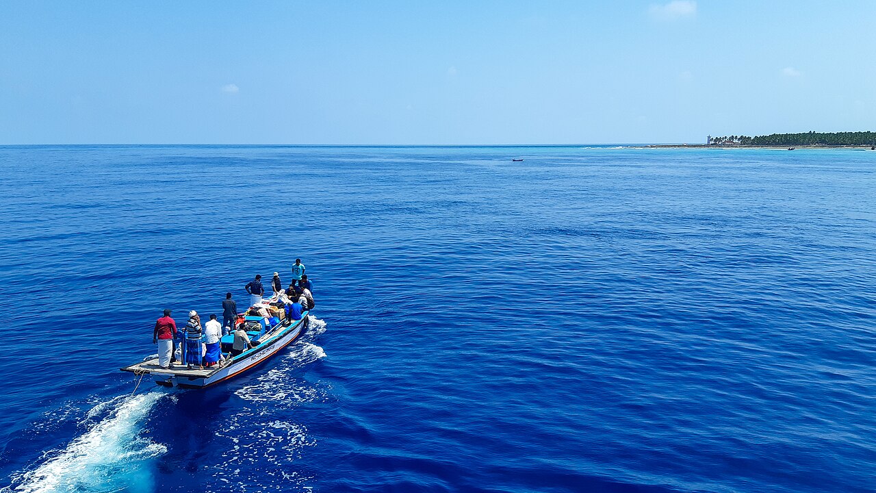 A boat sailing in the azure waters of the Lakshadweep Sea