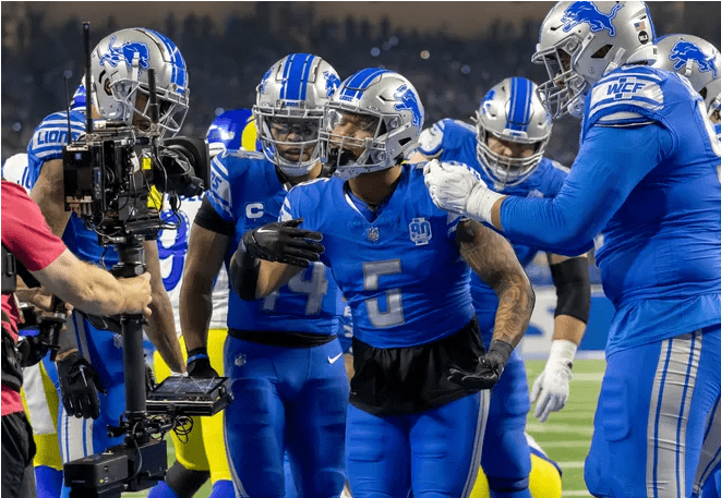 Teammates join in jubilation as Detroit Lions running back David Montgomery (5) celebrates his touchdown