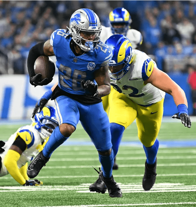 Against the Los Angeles Rams, Detroit Lions running back Jahmyr Gibbs (26) charges down the field with determination.