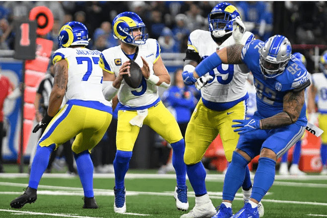 At Ford Field, Los Angeles Rams quarterback Matthew Stafford (9) steps back for a throw in the face-off against the Detroit Lions.